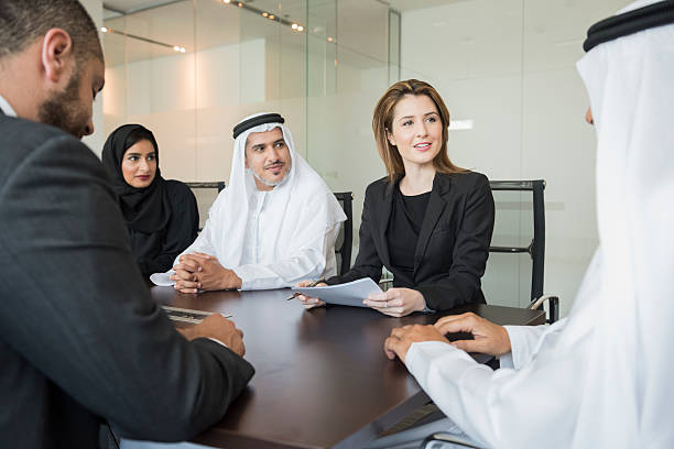 Business professionals discussing opportunities in KIZAD Free Zone around a conference table in modern office.